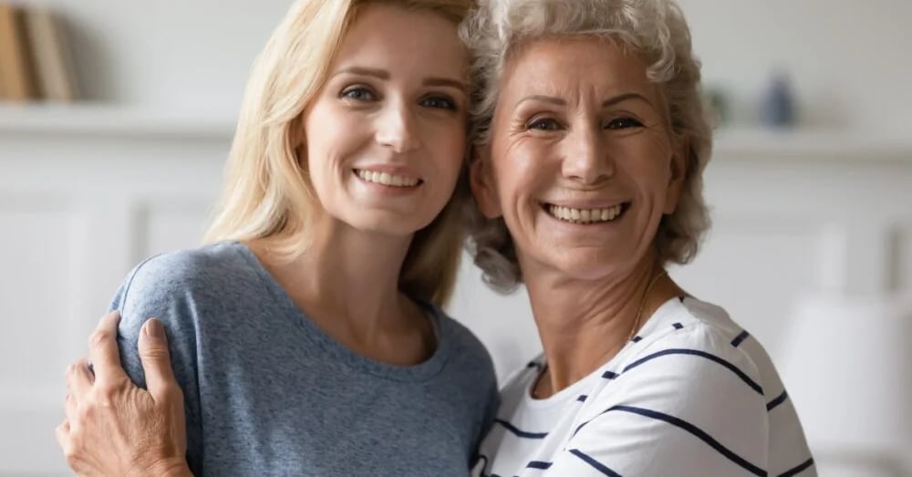 Two women smiling and hugging