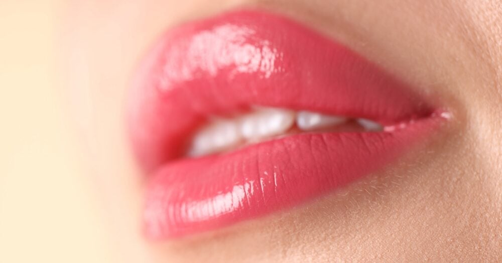 Close-up of a woman's full, plump lips showing natural-looking lip filler results