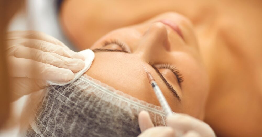 Close-up of a woman receiving a facial injection