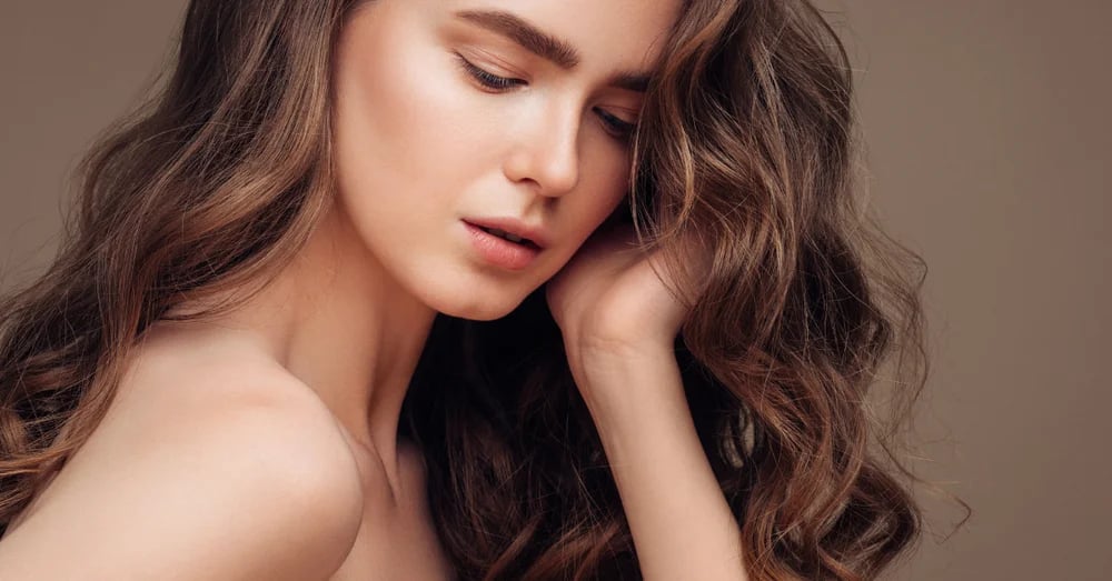 Woman touching her wavy hair